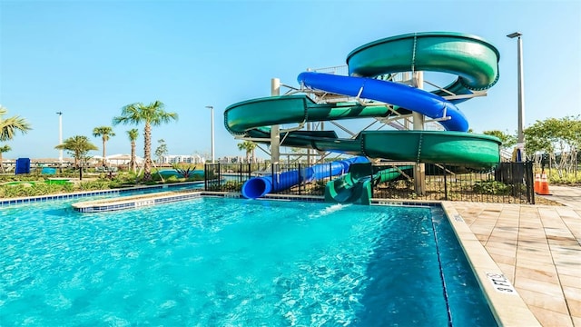 view of swimming pool with a water slide