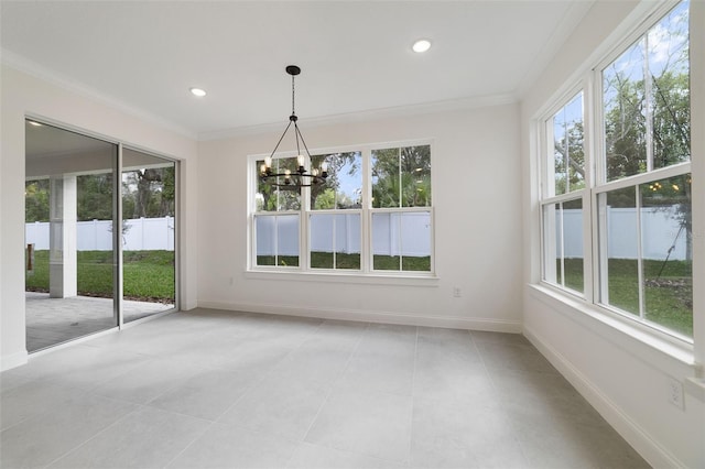 unfurnished dining area featuring a notable chandelier, crown molding, plenty of natural light, and light tile patterned floors