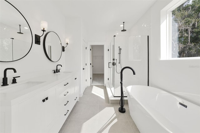 bathroom featuring tile patterned floors, a healthy amount of sunlight, separate shower and tub, and vanity