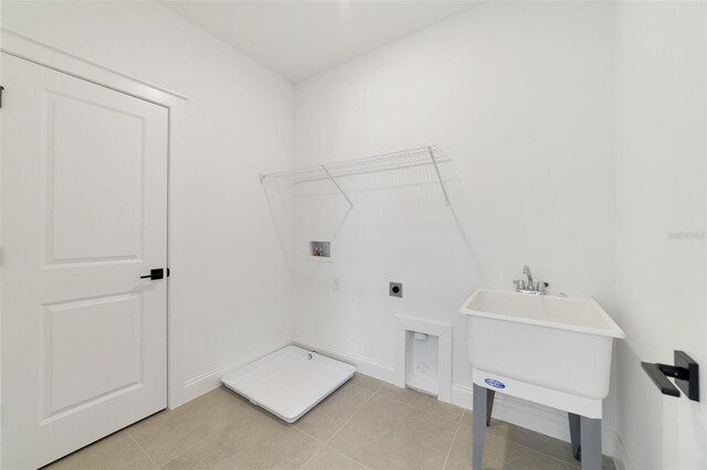 clothes washing area featuring hookup for a washing machine, hookup for an electric dryer, and light tile patterned floors