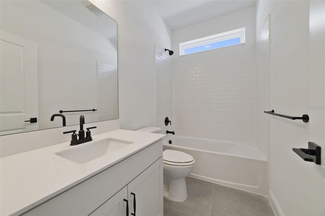 full bathroom featuring vanity, tile patterned flooring, tiled shower / bath combo, and toilet