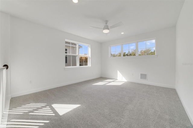 unfurnished room with ceiling fan and light colored carpet