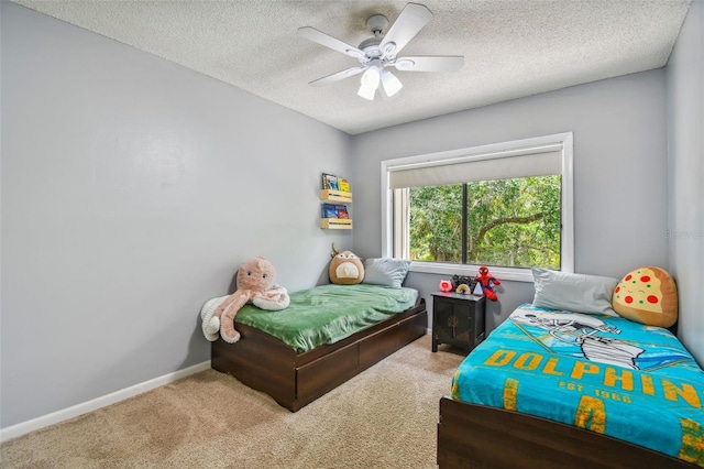 bedroom featuring carpet flooring, ceiling fan, and a textured ceiling