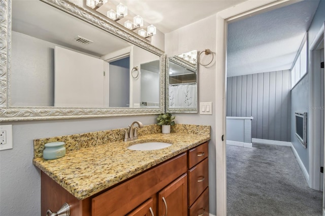 bathroom featuring a textured ceiling and vanity