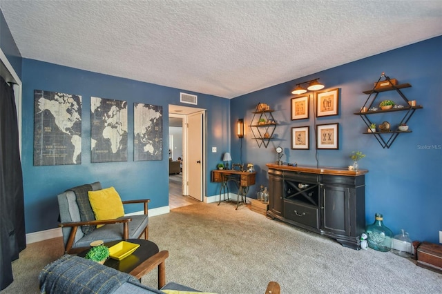 living area with a textured ceiling and carpet floors