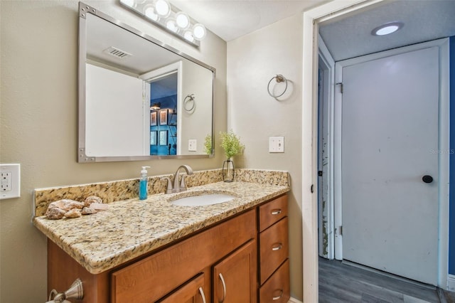 bathroom with vanity and hardwood / wood-style floors