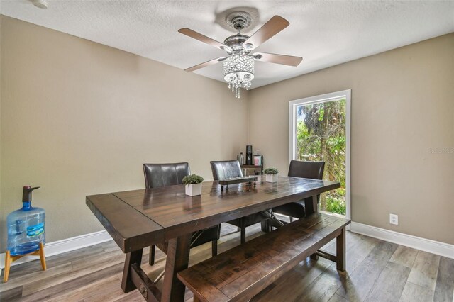 dining space featuring ceiling fan, a textured ceiling, and hardwood / wood-style flooring