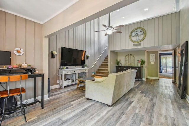 living room featuring ceiling fan and hardwood / wood-style floors