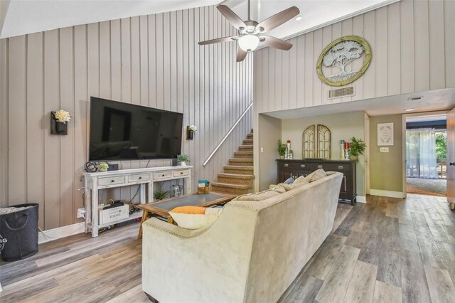 living room featuring ceiling fan and hardwood / wood-style flooring