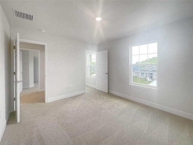 unfurnished bedroom featuring light carpet