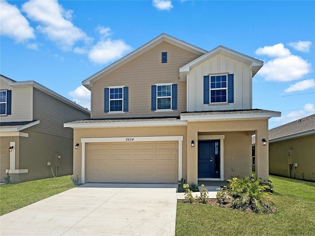 view of front of property featuring a front yard and a garage