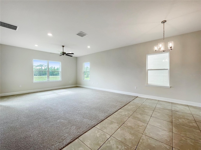 unfurnished room featuring light carpet and ceiling fan with notable chandelier