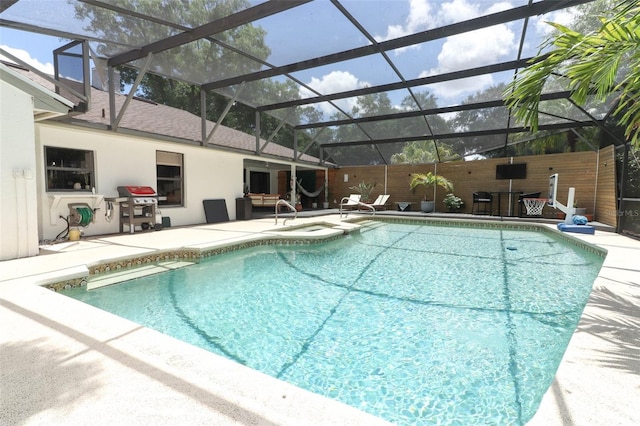 view of pool featuring an in ground hot tub, area for grilling, a patio, and glass enclosure