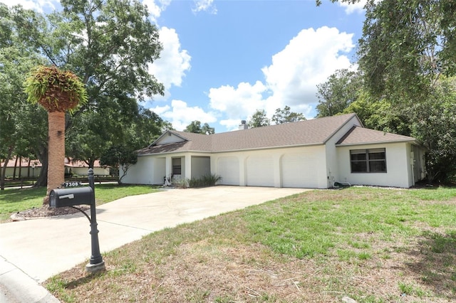 ranch-style house featuring a front lawn and a garage