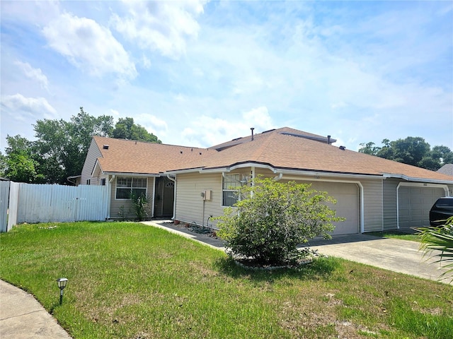 single story home featuring a garage and a front lawn