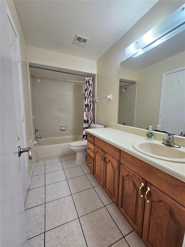 full bathroom with shower / bath combo with shower curtain, tile patterned flooring, vanity, and toilet