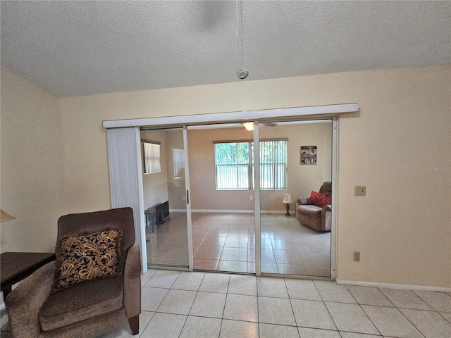 sitting room featuring light tile patterned floors and a textured ceiling