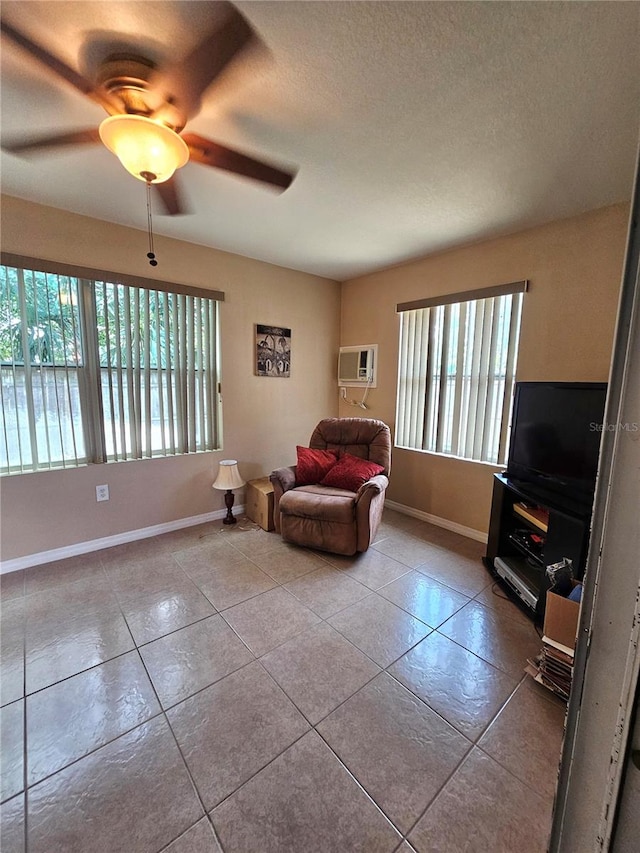 unfurnished room with plenty of natural light, ceiling fan, light tile patterned flooring, and an AC wall unit