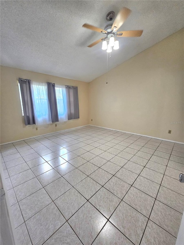 tiled empty room with a textured ceiling and ceiling fan