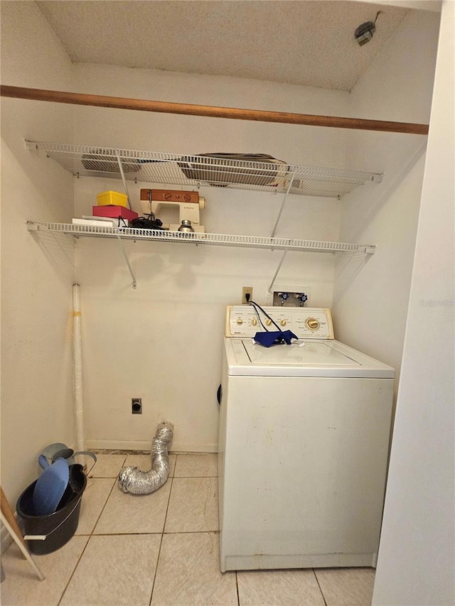 washroom featuring washer / clothes dryer and light tile patterned floors