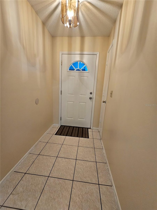 doorway featuring tile patterned flooring and a textured ceiling