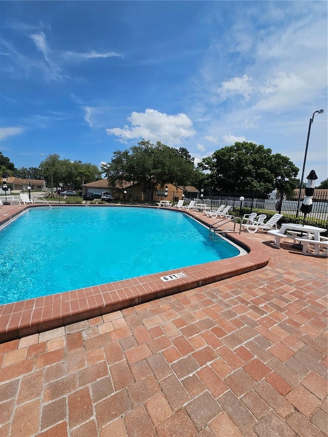 view of swimming pool with a patio