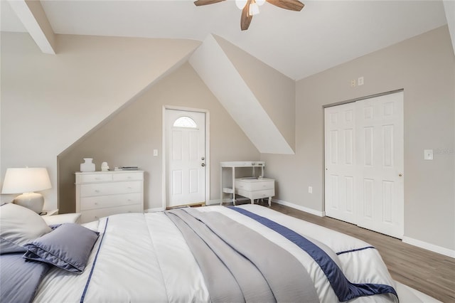 bedroom with a closet, ceiling fan, vaulted ceiling, and hardwood / wood-style floors