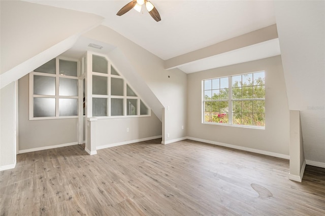 additional living space featuring ceiling fan, light hardwood / wood-style flooring, and vaulted ceiling