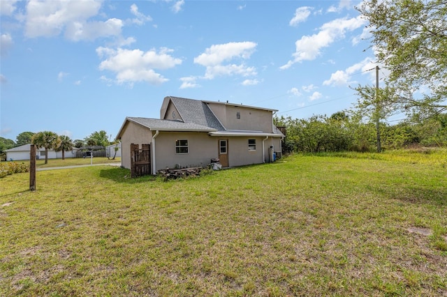 back of property featuring a lawn