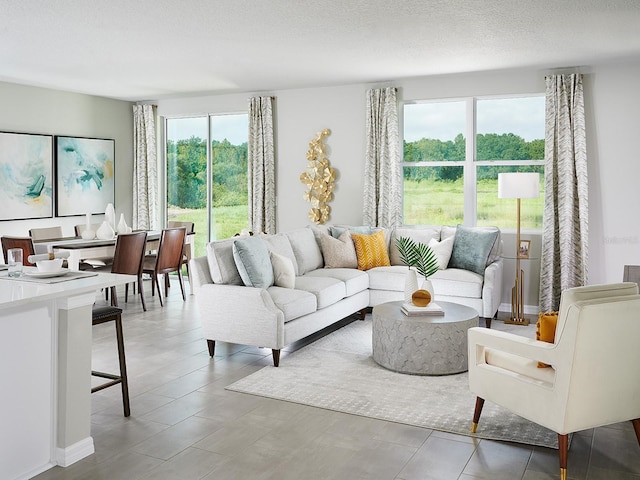 tiled living room featuring a textured ceiling