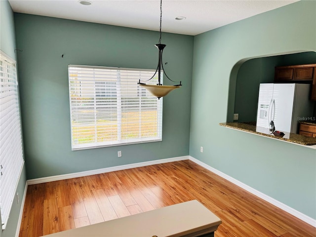 unfurnished dining area with light hardwood / wood-style flooring