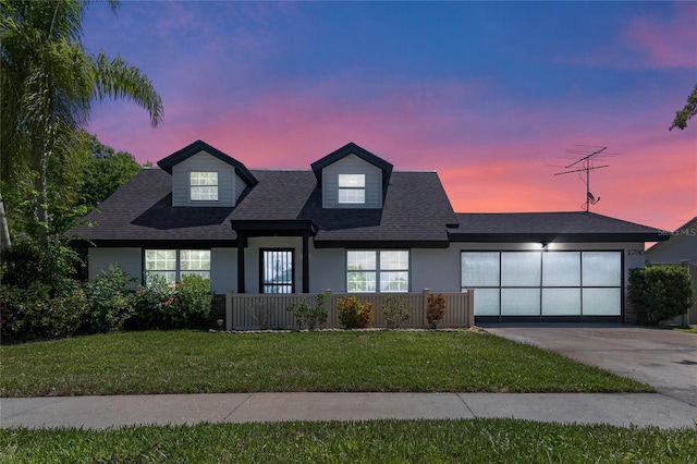 view of front of home with a lawn and a garage