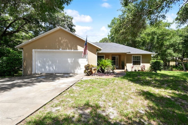 ranch-style home with a garage and a front lawn