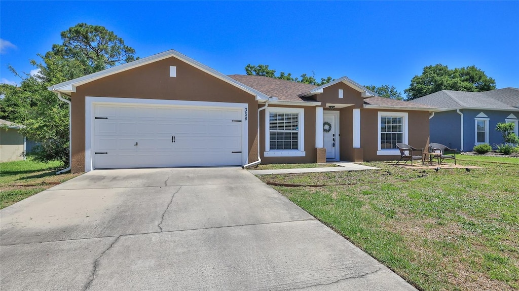 ranch-style house with a front lawn and a garage