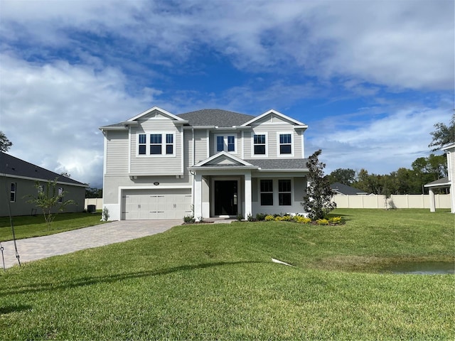 view of front of property featuring a garage and a front yard