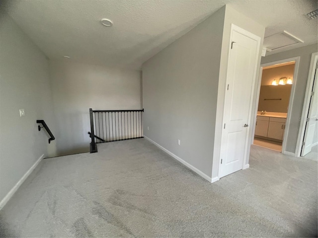 interior space with light colored carpet and a textured ceiling