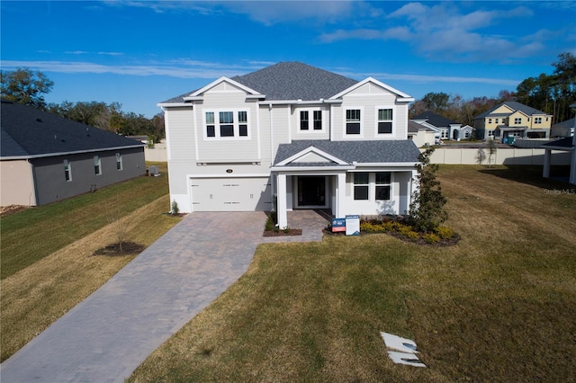 view of front facade with a garage and a front yard