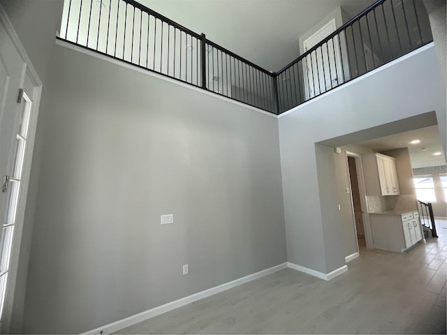 interior space featuring hardwood / wood-style flooring and a high ceiling