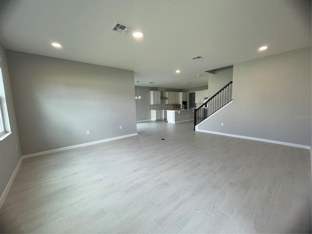 unfurnished living room with light wood-type flooring