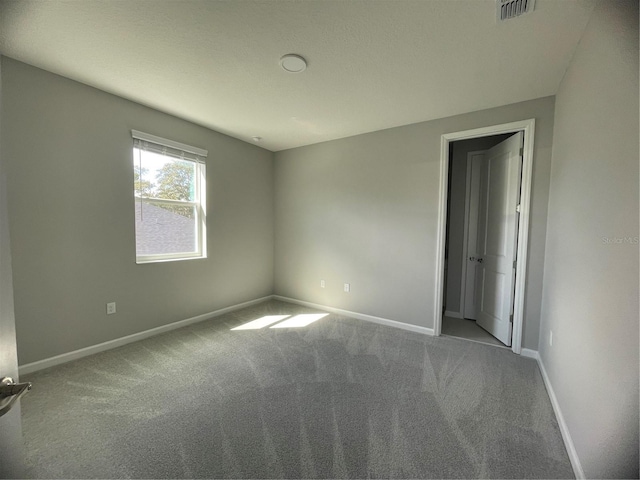 unfurnished room with light carpet