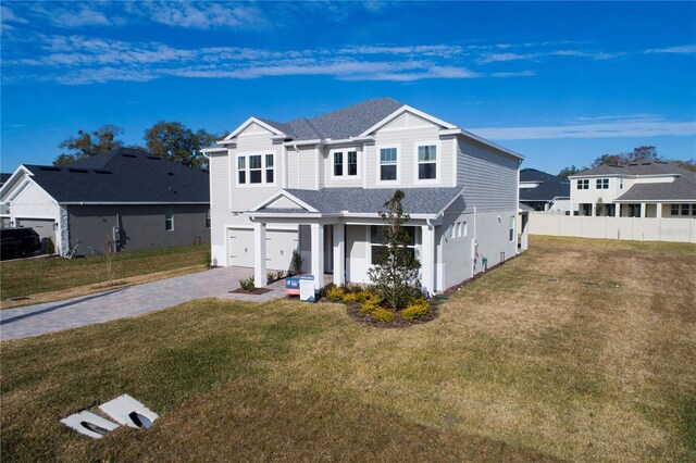 view of property with a garage and a front yard