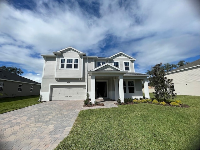 view of front of property with a garage and a front lawn