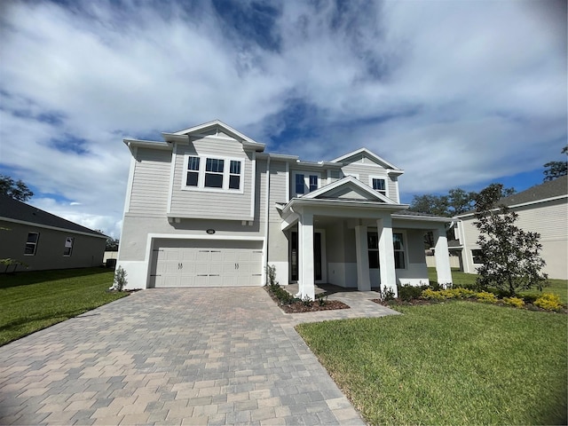 view of front of house featuring a garage, a front yard, and a porch