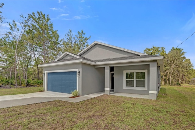 view of front of home with a garage and a front lawn