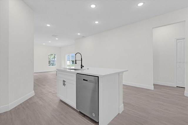 kitchen featuring dishwasher, a center island with sink, light wood-type flooring, sink, and white cabinetry