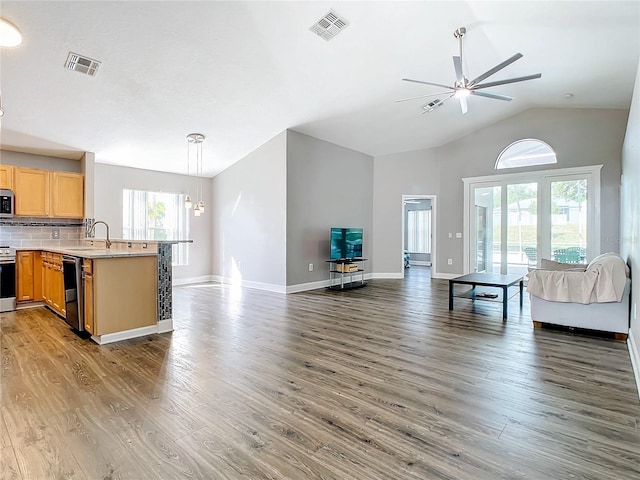 kitchen featuring sink, dark wood-type flooring, appliances with stainless steel finishes, backsplash, and hanging light fixtures