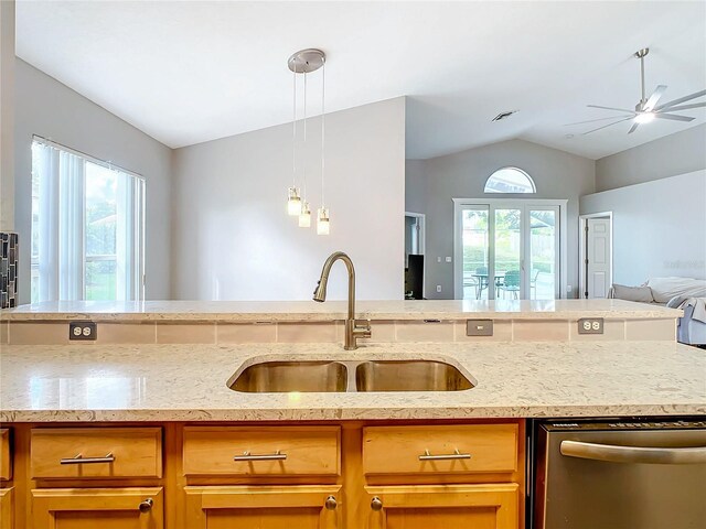 kitchen with ceiling fan, sink, dishwasher, light stone countertops, and lofted ceiling