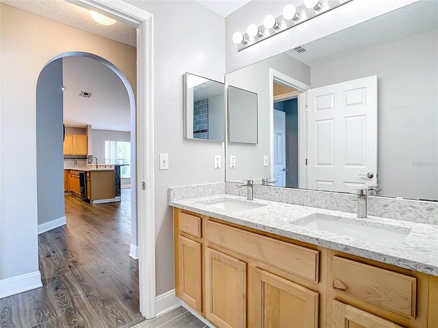 bathroom featuring hardwood / wood-style flooring and double sink vanity