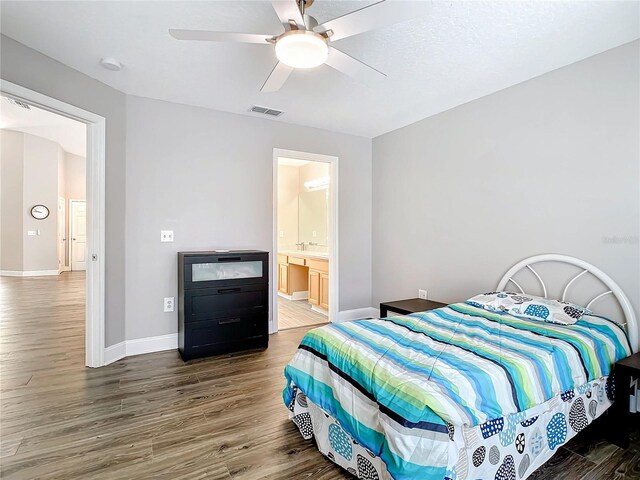 bedroom with ceiling fan, hardwood / wood-style flooring, and connected bathroom