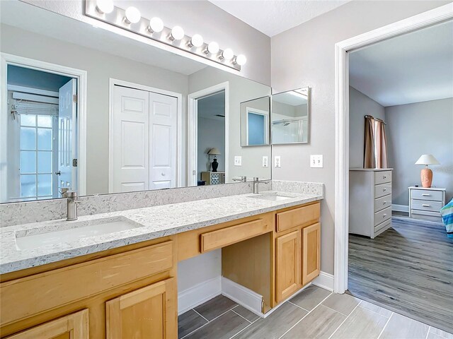 bathroom featuring dual vanity and hardwood / wood-style flooring